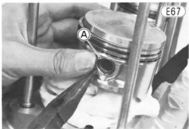 Close-up of a hand using a tool to adjust the internal combustion engine cylinder (no text or symbols visible)