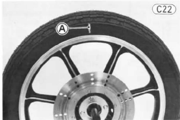 Close-up of a car wheel rim with labeled component A and part number C22 (no text or symbols on the main subject)