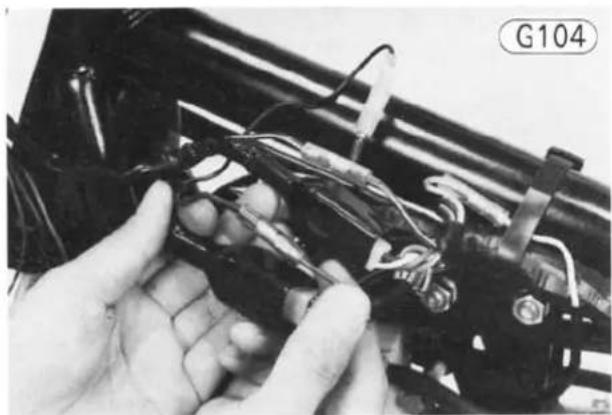 Close-up of hands assembling electronic components with wires and connectors (no visible text or symbols)