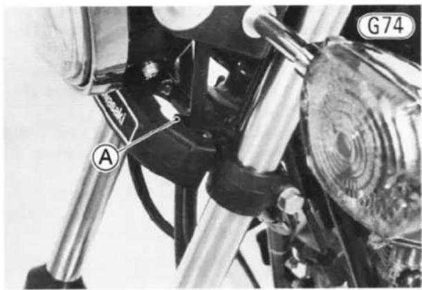 Close-up of a motorcycle's front wheel and side-mounted brake lever (no visible text or symbols)