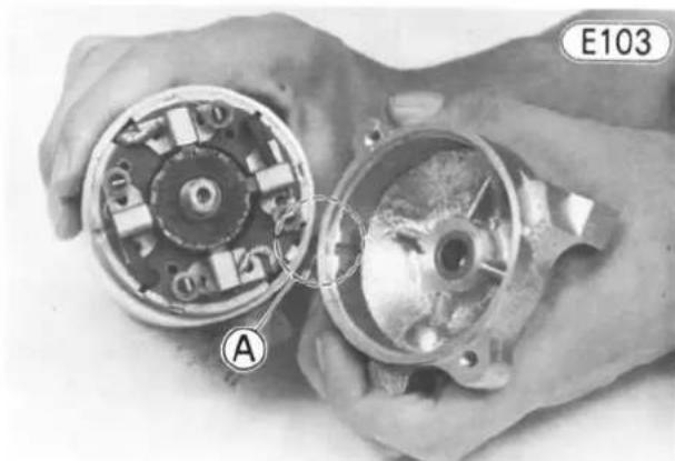 Close-up of hands assembling a mechanical component with labeled section A (no readable text or symbols)