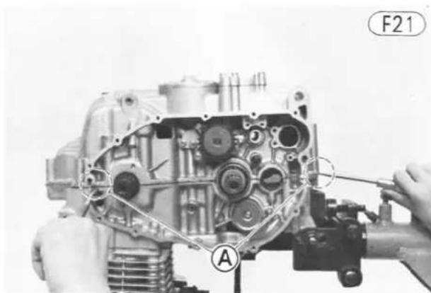 Close-up of a mechanical assembly with labeled parts (A and F21), no readable text or symbols beyond labels
