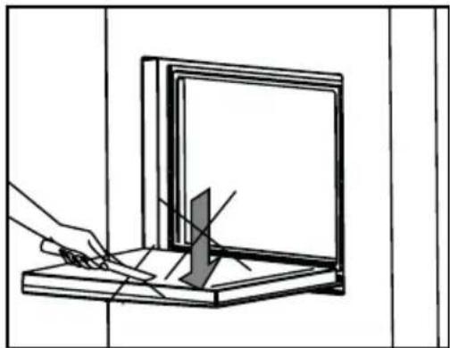 Line drawing of a hand using a tool to cut or mark a rectangular object on a flat surface (no text or symbols).