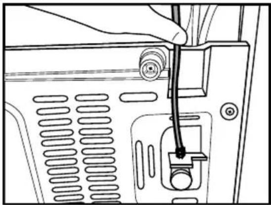 Line drawing of a hand inserting a cable into a device panel (no text or symbols).