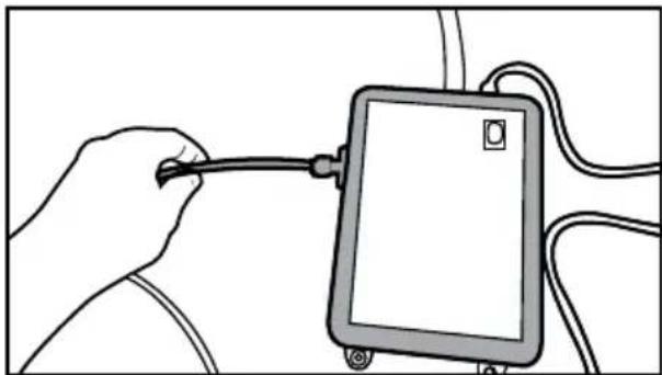Illustration of a hand holding a cable inserted into a tablet device (no text or symbols visible)