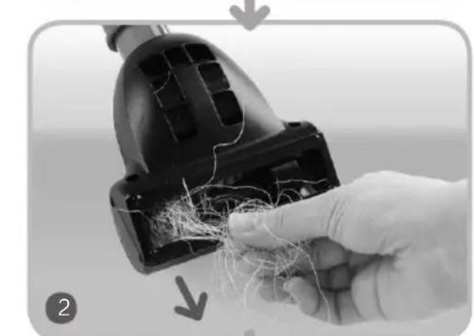 Close-up of a hand holding a black vacuum cleaner with visible wire and fiber, no text or symbols present.