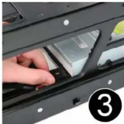 Close-up of a hand inserting a component into a black plastic housing (no visible text or symbols)