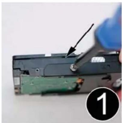 Close-up of a hand using a screwdriver to work on a green electronic device (no text or symbols visible)