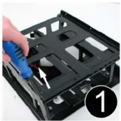 Hand using a blue tool to adjust or install a black plastic chassis component (no text or symbols visible)