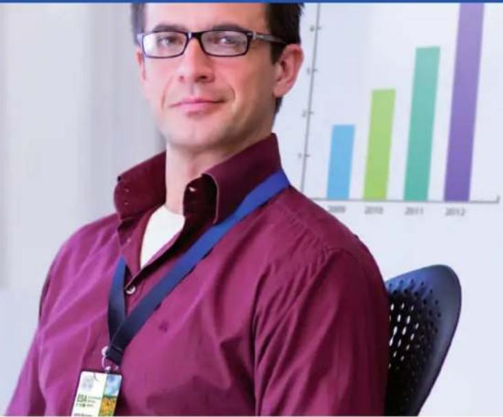 Portrait of a man in glasses and maroon shirt with a lanyard, against a background bar chart showing years 1999–2012.