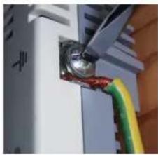 Close-up of a server rack with a metallic connector and colored wires attached (no visible text or symbols)