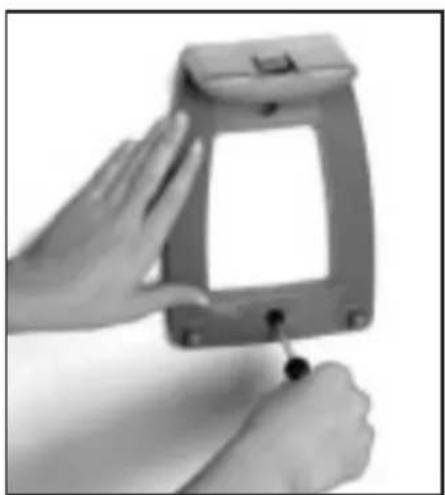 Close-up of a hand holding a small electronic device with a handle, no visible text or symbols