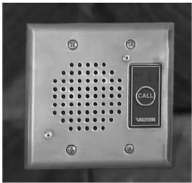 Close-up of a metallic electronic device with a perforated grille and a call button labeled 'CALL' (no readable text beyond label)