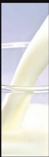 Close-up of a white milk being poured into a glass (no text or symbols visible)