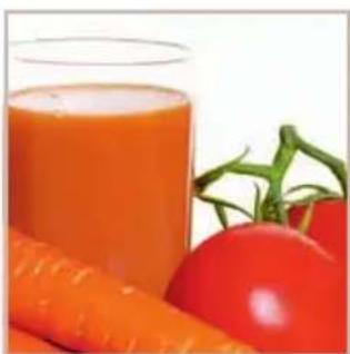 Close-up of a glass of orange juice with fresh tomatoes and carrots in the background (no text or symbols visible)