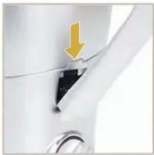 Close-up of a mechanical component with a yellow arrow pointing to a section (no visible text or symbols)