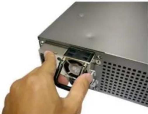 Hand inserting a drive into a server rack (no visible text or symbols)