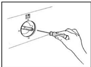Hand holding a screwdriver to adjust a circular component (no text or symbols visible)