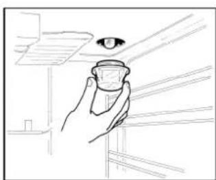 Line drawing of a hand holding a small object with an eye above, inside a room with shelves and a window (no text or symbols)