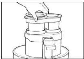 Line drawing of a hand placing a small object into a cylindrical container (no text or symbols)