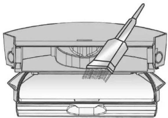 Technical line drawing of a mechanical device with a brush applying material to a base (no text or symbols)