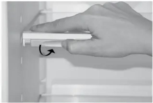 Hand holding a white cylindrical object with an arrow indicating rotation (no text or symbols visible)