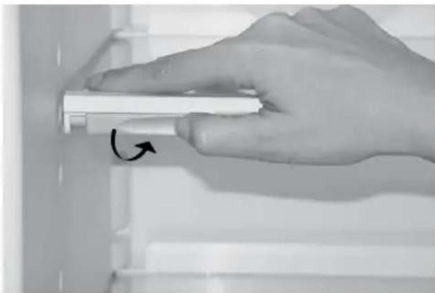 Hand holding a white rectangular object with an arrow indicating rotation (no text or symbols visible)
