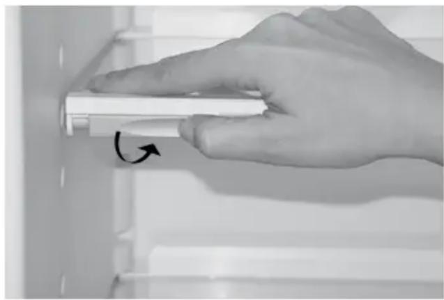 Hand holding a white cylindrical object with an arrow indicating rotation (no text or symbols visible)