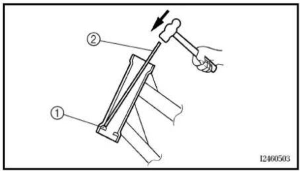 Technical diagram showing a hand operating a hammer tool with labeled parts, including numbered annotations.