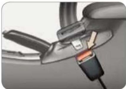 Close-up of a car seatbelt connector with orange and black buttons inserted (no text or symbols visible)