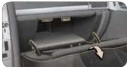 Interior view of a vehicle showing a car seatbelt and attached cable (no visible text or symbols)