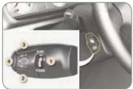 Close-up of a car dashboard and steering wheel with labeled buttons (no readable text or symbols)