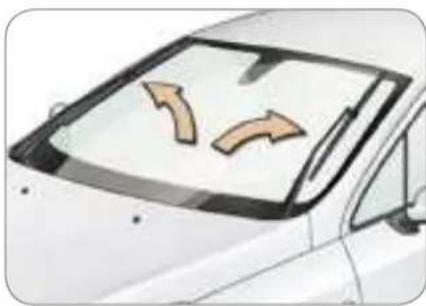 Illustration of a car with two curved arrows pointing outward from the windshield (no text or symbols)