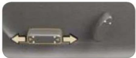 Close-up of a metallic electronic component with two arrows pointing left and one on the right side, next to a small irregular object (no visible text or symbols)