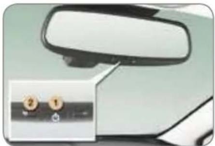 Close-up of a car front mirror and side mirror with a small inset showing two labeled buttons (2 and 1) on a control panel.
