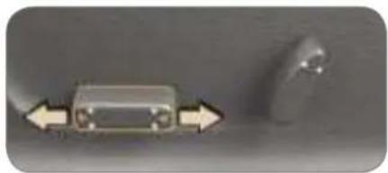 Close-up of a small electronic component with directional arrows indicating movement, next to a blurred circular object (no visible text or symbols)