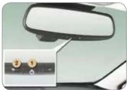 Close-up of a car front mirror and side panel with two labeled buttons (no text or symbols visible)