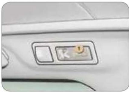 Close-up of a car's front panel with a control switch and a circular icon on the door (no text or symbols visible)