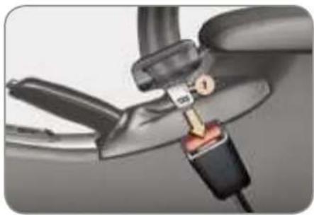 Close-up of a hand holding a connector with a plug inserted, showing mechanical parts and wiring (no text or symbols visible)
