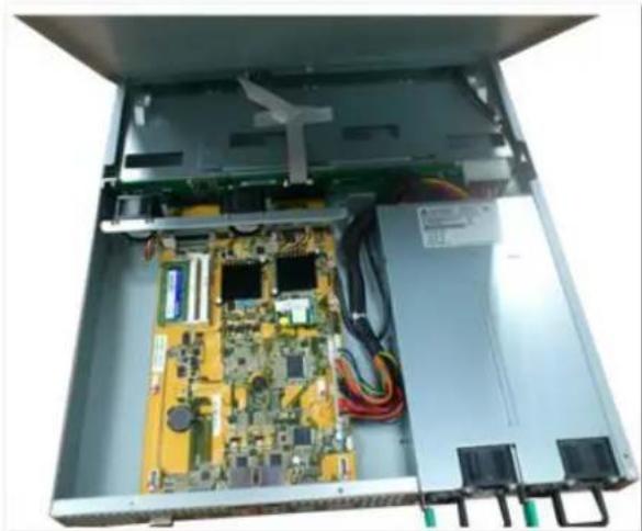 Interior view of an open electronic device showing a circuit board with various components and wiring (no visible text or symbols)