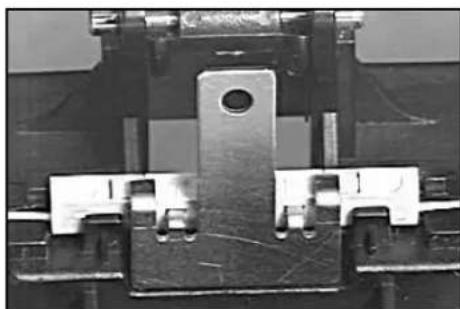 Close-up of a mechanical component with metallic parts and a central hole (no visible text or symbols)