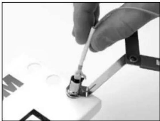 Close-up of a hand using a screwdriver to work on a small electronic component (no visible text or symbols)