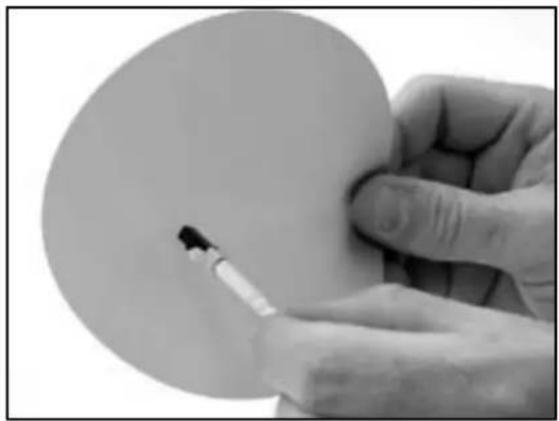 Close-up of a hand holding a small object, possibly a tool or tool, with no visible text or symbols.