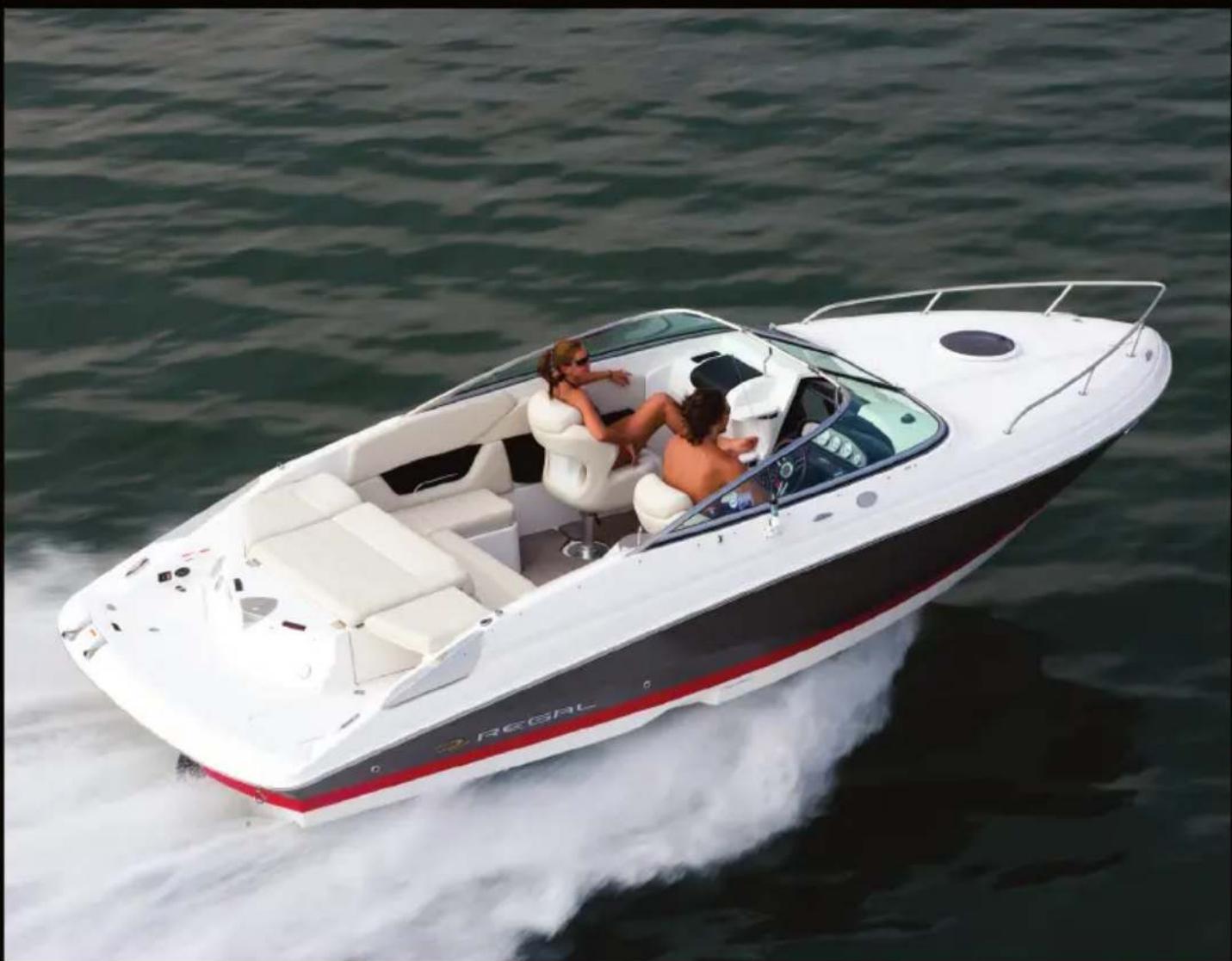Top-down view of a white and black speedboat with red and black stripes cruising on calm water, passengers visible inside (no text or symbols)