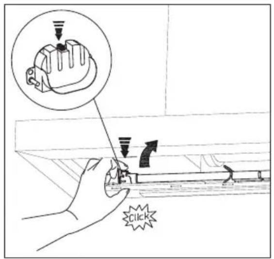 Technical diagram showing a hand using a tool to adjust or install a component, with an inset magnified view highlighting the component's feature.