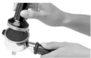 Close-up of hands using a handheld tool to press or install a mechanical component (no visible text or symbols)