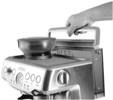 Hand operating a microwave oven with a bowl on top (no visible text or symbols)