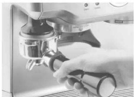 Close-up of a hand using a coffee machine for a kitchen press tool (no visible text or symbols)