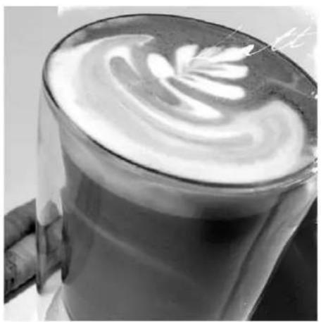 Close-up of a glass of light with a swirling white cream swirl on top, possibly a coffee or tea bath (no text or symbols visible)