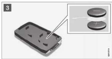 Close-up of a black plastic electronic component being inserted, with two circular buttons visible (no text or symbols)